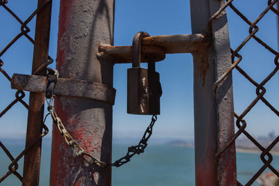 Close-up of padlocks on metal fence