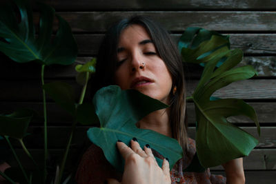 Close-up portrait of young woman with eyes closed