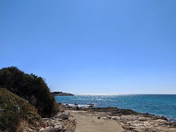 Scenic view of sea against clear blue sky