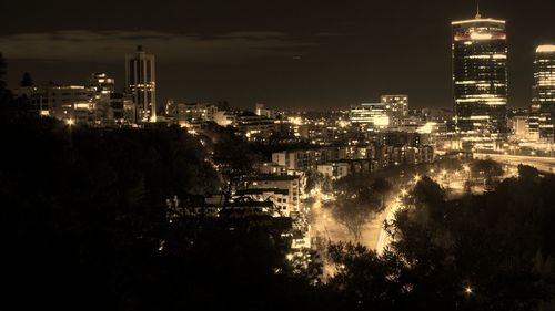 High angle view of illuminated buildings in city at night