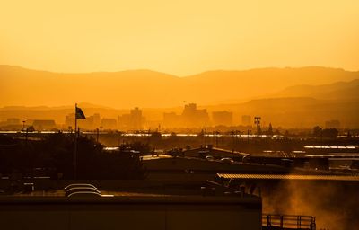 Silhouette buildings against sky during sunset