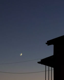 Low angle view of silhouette moon against sky at night