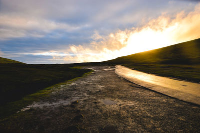 Road amidst landscape against sky during sunset