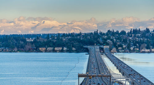 Seattle floating bridges with mountains behind in the evening.