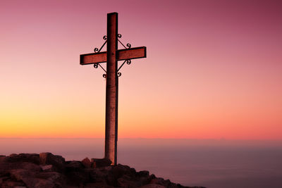 Cross against clear sky during sunset