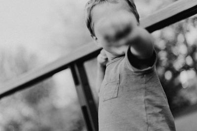 Boy standing by railing