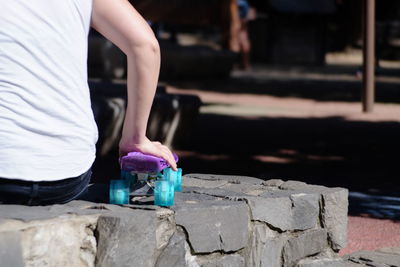 Close-up of person holding a skateboard