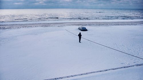High angle view of man on snow covered field