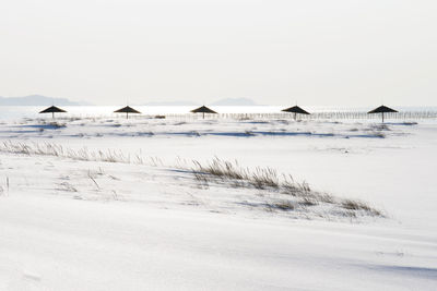 Scenic view of sea against clear sky during winter