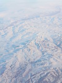 High angle view of snowcapped landscape against sky