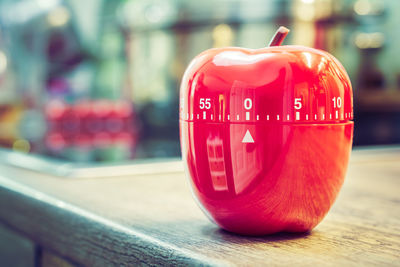 Close-up of red container with numbers on table