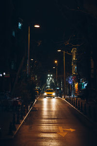 Illuminated city street at night