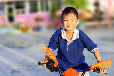 Smiling boy on motorcycle during winter