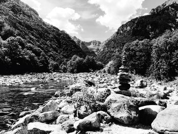 Scenic view of rocks in forest against sky