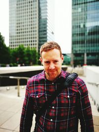 Portrait of man standing against buildings