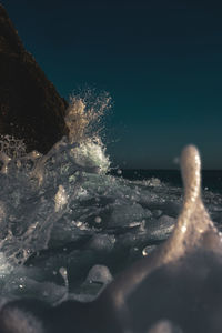 Close-up of water splashing on rocks