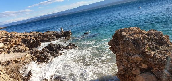 Rocks on beach against sky