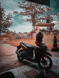 Rear view of man riding motorcycle on street in city