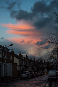 View of cityscape against dramatic sky