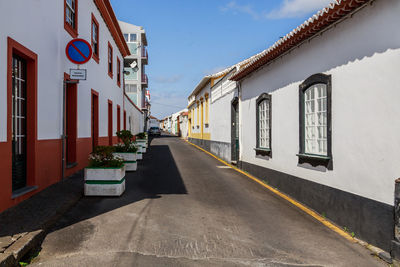 Street amidst buildings against sky