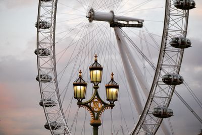 Low angle view of street light against millennium wheel