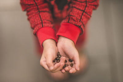Close-up of woman holding red hand