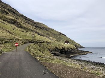 Road by sea against sky