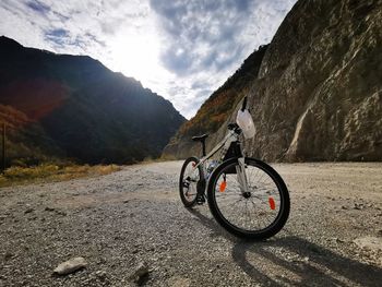 Bicycle on road against mountains