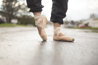 Low section of child walking on street