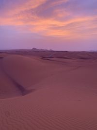 Scenic view of desert against sky during sunset