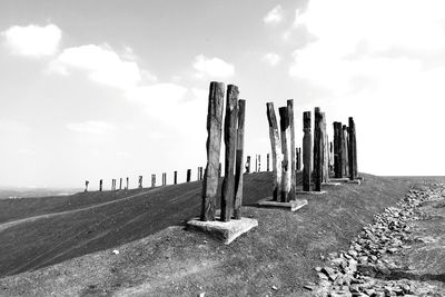 Wooden fence on field against sky