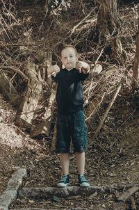 Full length portrait of boy standing on land
