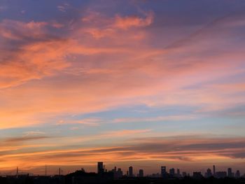 Silhouette buildings against sky during sunset