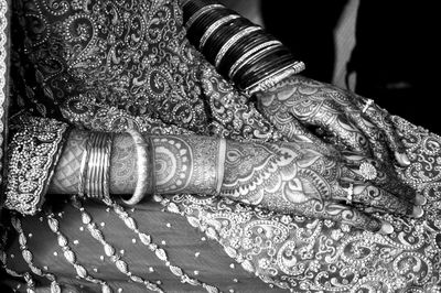 Midsection of woman with heena tattoo during wedding ceremony