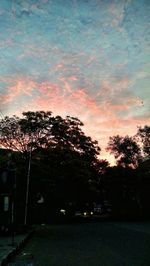 View of trees against cloudy sky