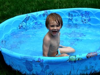 Portrait of shirtless boy in swimming pool