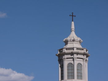 Low angle view of tower and building against sky