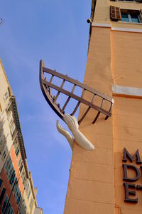 Low angle view of building against blue sky