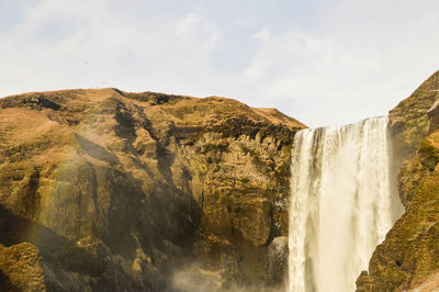 Panoramic view of waterfall against sky