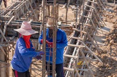 Worker use pile wire bundle steel rod on foundation building in construction site.