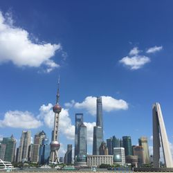 Low angle view of oriental pearl tower and modern buildings against sky