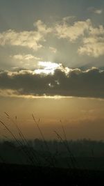 Scenic view of silhouette field against sky during sunset