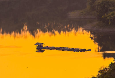 Scenic view of lake against orange sky