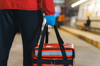 Rear view of man standing at railroad station platform