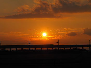 Silhouette bridge against sky during sunset