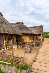 Viking village replica with thatched roof houses.