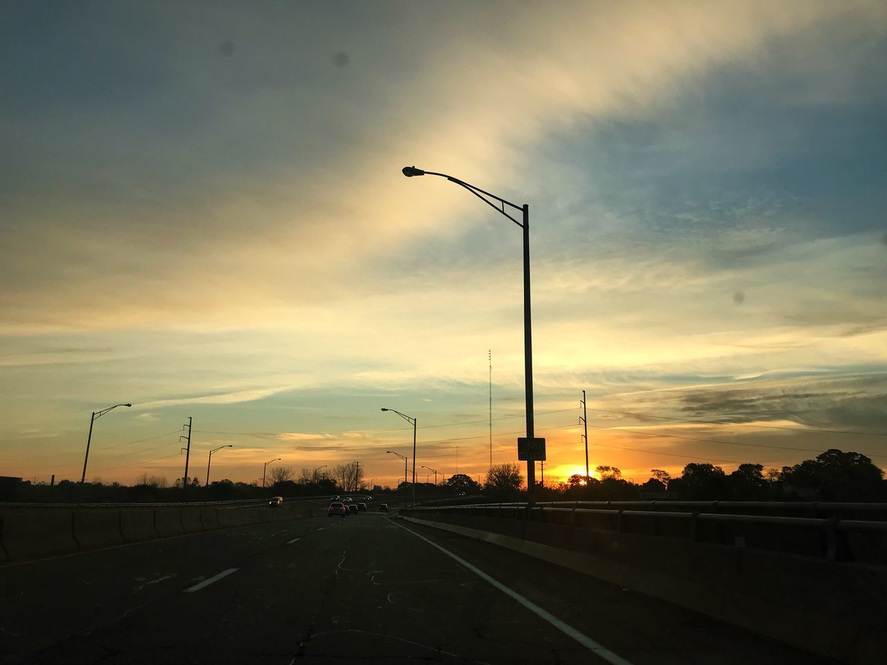 ROAD BY SILHOUETTE TREES AGAINST SKY DURING SUNSET