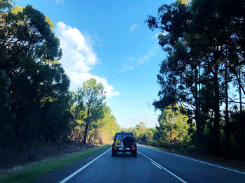 Cars on road against sky