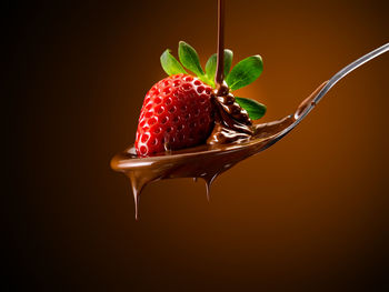 Close-up of strawberry over black background