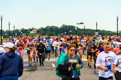 Crowd on street against clear sky